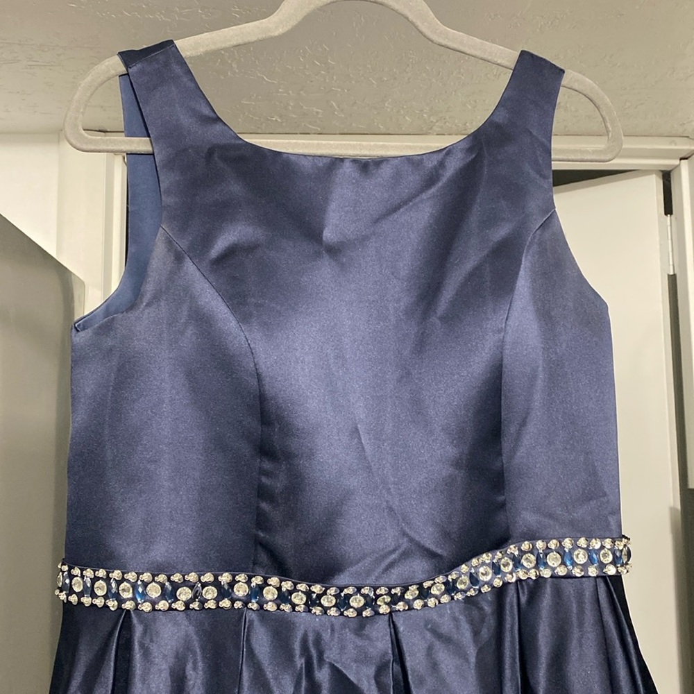 Beautiful navy blue ball gown with a sequined belt and a corset back.